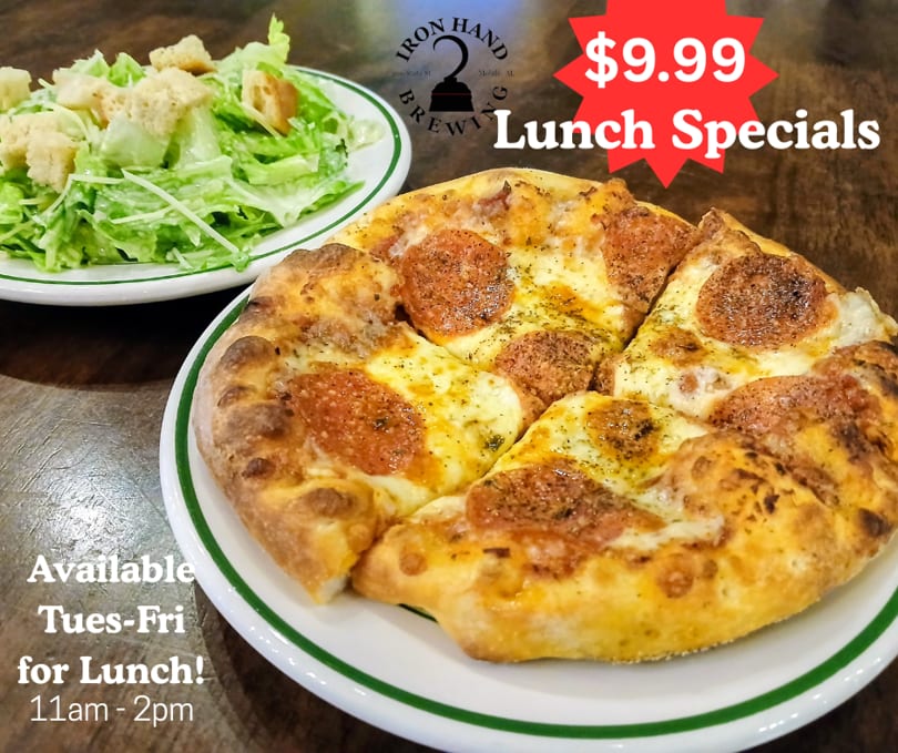 Pepperoni pizza and a side salad on a wooden table, advertising Iron Hand Brewing lunch specials.